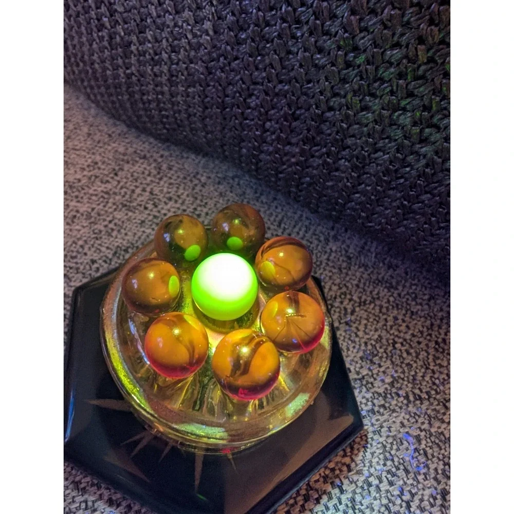 7 Red Cadmium Marbles W/ 1 Burmese Marble On VTG Flower Frog. (Included)